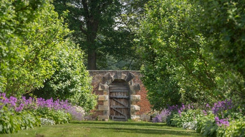The Walled Garden gate bordered by apple trees